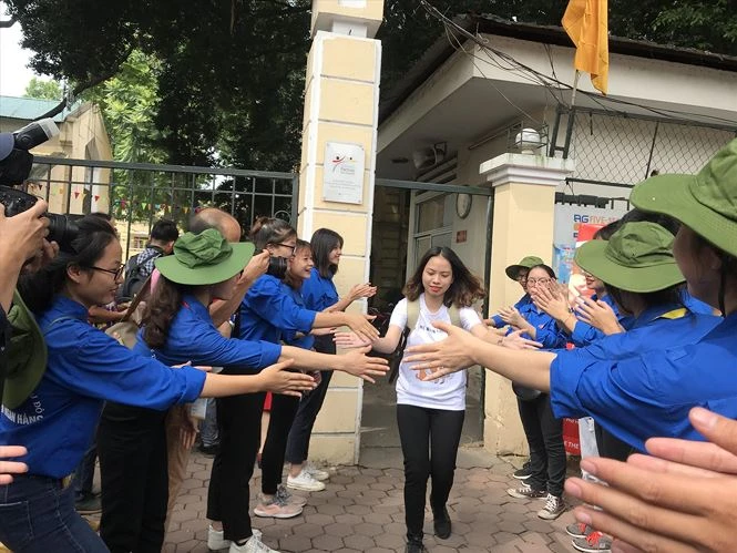 Thật đẹp trước hình ảnh sinh viên tình nguyện Học viện Ngân hàng đứng vỗ tay chào đón thí sinh hoàn thành bài thi tại điểm thi Trường THPT Việt Đức. Ảnh: Xuân Phú