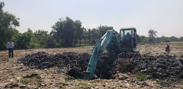 Sau khi máy xúc đào lớp đất mặt lên, rác bắt đầu lộ ra Sau khi máy xúc đào lớp đất mặt lên, rác bắt đầu lộ ra