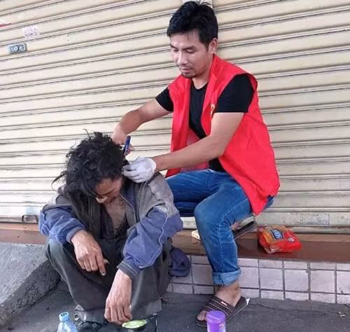 Cai Yanqiu cắt tóc cho một người vô gia cư. Cai Yanqiu cắt tóc cho một người vô gia cư. Ảnh: Peoples Daily