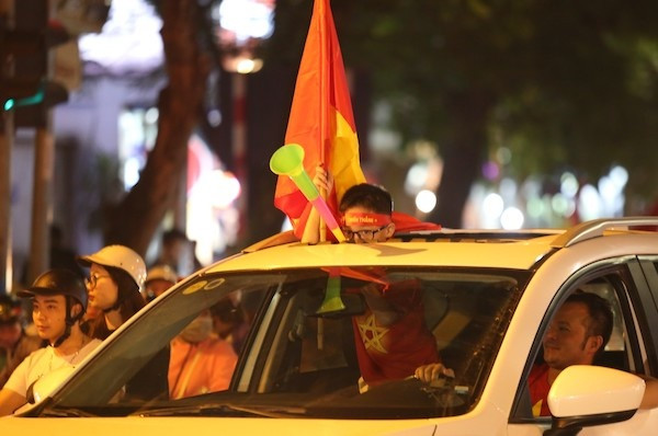Người hâm mộ mang theo cờ đỏ sao vàng xuống phố. Ảnh: Gia Chính 24cabf4acf2a2c74753b-2044-1543758678.jpg