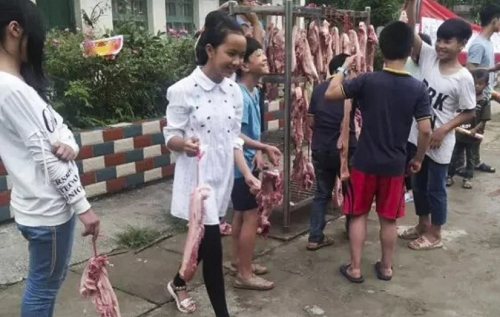 Mỗi học sinh giỏi nhận được bằng khen và 600g thịt lợn. Mỗi học sinh giỏi nhận được bằng khen và 600g thịt lợn. Ảnh: SCMP