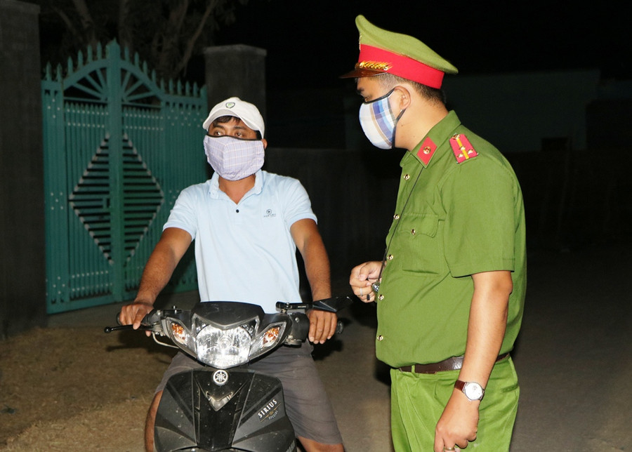 Lực lượng công an tuyên truyền cho người dân hạn chế đi ra ngoiaf khu vực cách ky. (Ảnh: Ý Thảo).