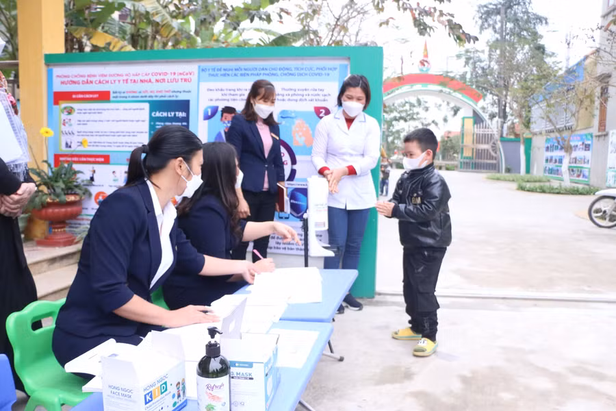 Trẻ tới trường được cô giáo hướng dẫn rửa tay sát khuẩn, đo thân nhiệt trước khi vào lớp.