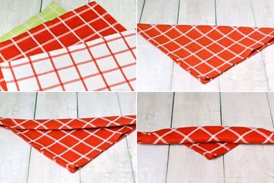 Gấp đôi chiếc khăn theo đường chéo, sau đó từ nếp gấp đường chéo bạn gấp xuống 3cm. Tiếp tục gấp cuộn các nếp gấp với bề rộng 3cm, gấp đến khi cách góc vuông bên dưới 3cm thì dừng lại.