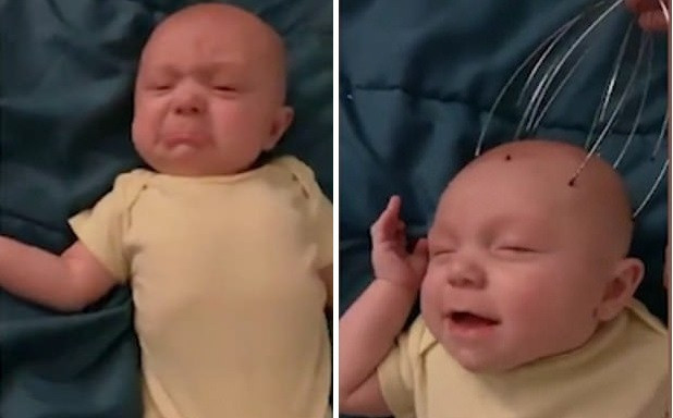 Vừa mới mếu máo nhưng cậu bé đã cười thích thú vì được mát xa đầu.