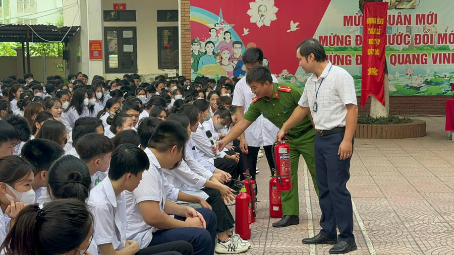 Học sinh đặt câu hỏi với các báo cáo viên về kỹ năng phòng cháy tại sân trường.