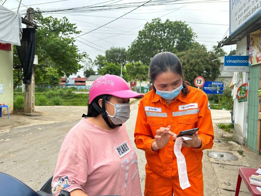 Cán bộ Công ty Điện lực Điện Biên phổ biến với khách hàng.