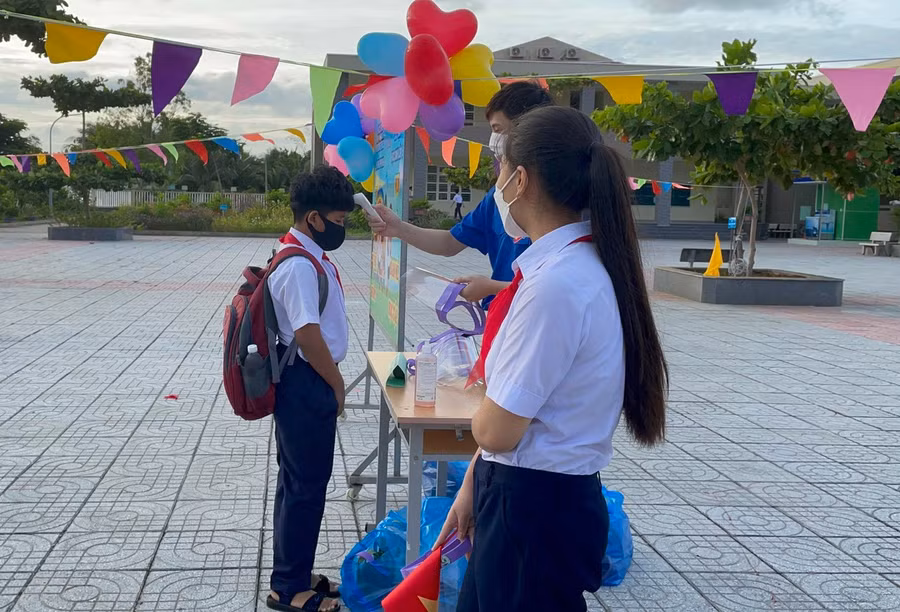 Học sinh phải đeo khẩu trang, đo thân nhiệt và sát khuẩn tay trước khi vào lớp.