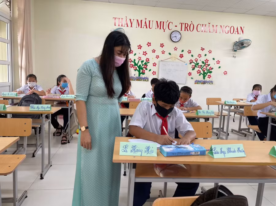 Cô trò Trường THCS Lê Hồng Phong trong một giờ học trực tiếp trên lớp, học sinh ngồi theo giãn cách.