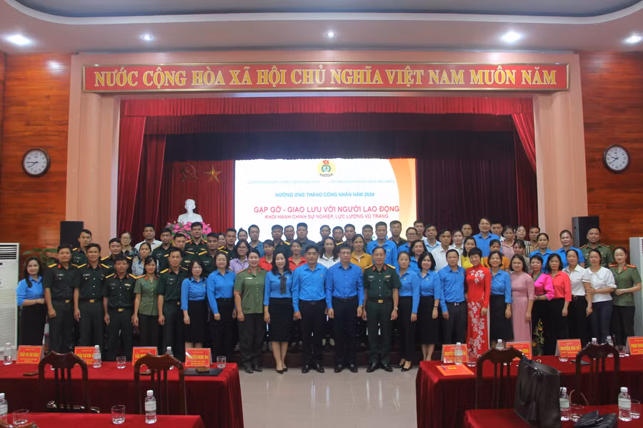 Các đại biểu chụp ảnh lưu niệm với người lao động.