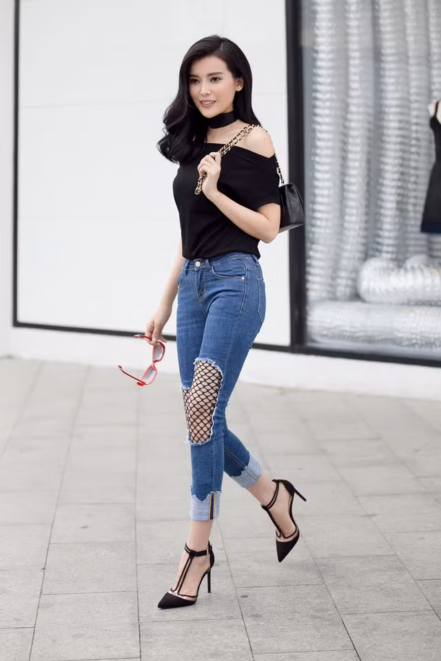 Áo trễ vai bánh bèo và quần jeans rách cá tính.