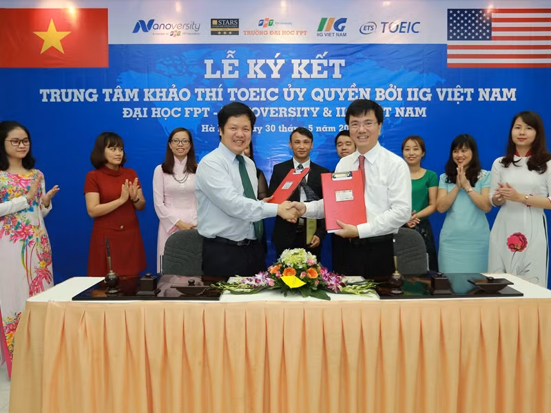 TS Đàm Quang Minh - Hiệu trưởng Trường đại học FPT, Đại diện FPT Nanoversity và ông Đoàn Hồng Nam - Chủ tịch HĐQT IIG Việt Nam trao hợp đồng ký kết giữa hai bên