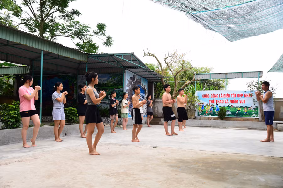 Thầy trò cùng tập các động tác khởi động trước khi vào học bơi.