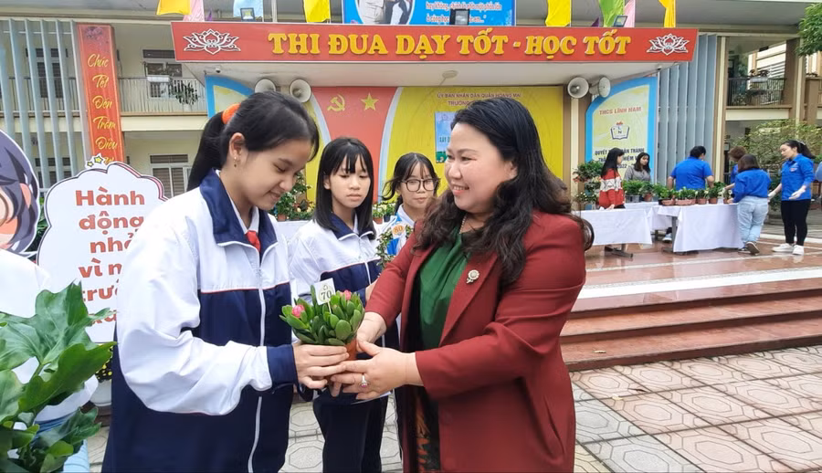 Cô Trần Lệ Khanh trao cây xanh cho các em học sinh ở các lớp.