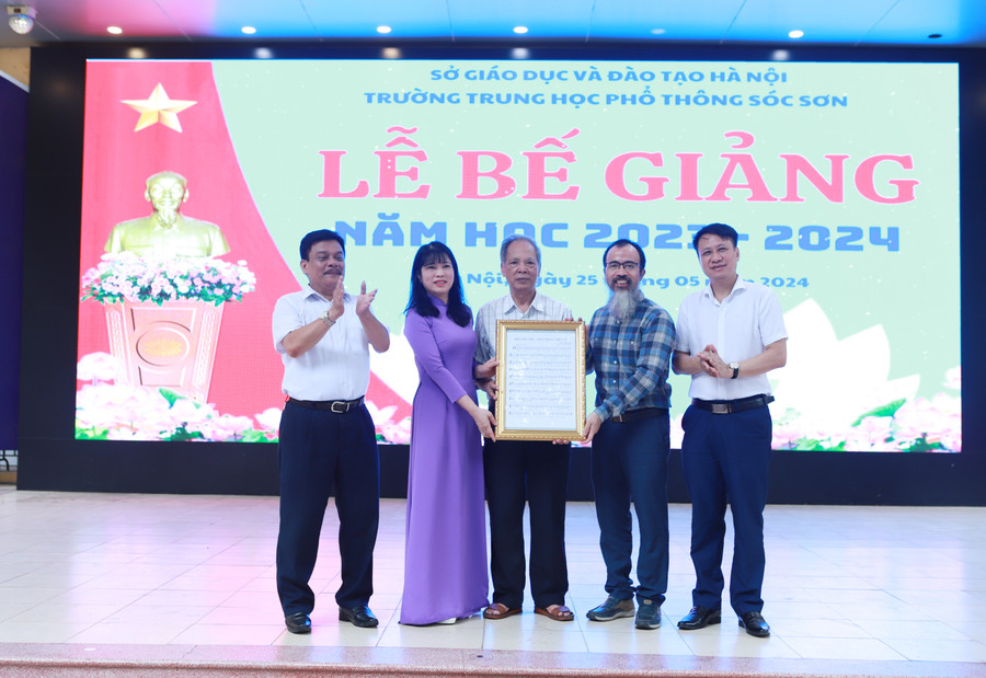 Nhạc sĩ Mai Bá Trần (thứ 2 từ phải sang) trao lại bản quyền bài hát truyền thống cho đại diện Trường THPT Sóc Sơn.