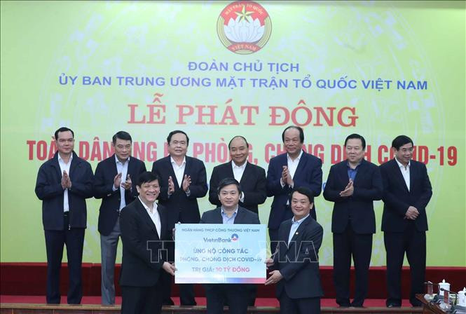 Thủ tướng Nguyễn Xuân Phúc và các đại biểu chứng kiến các tổ chức và cá nhân quyên góp ủng hộ công tác phòng, chống dịch COVID-19. Chú thích ảnh