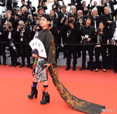 Một gương mặt khác chơi trội với trang phục "trước ngắn sau dài", cộng thêm quạt và tất "cọc cạch" gây chướng mắt. Một gương mặt khác chơi trội với trang phục "trước ngắn sau dài", cộng thêm quạt và tất "cọc cạch" gây chướng mắt.