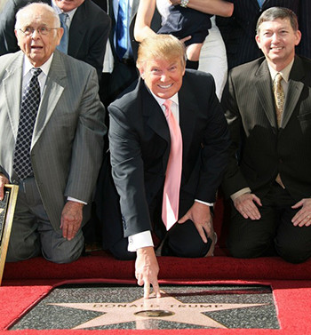 [Caption]Donald Trump, center, then producer of NBCs The Apprentice, poses after he was honored by the 2,327th star on the Hollywood Walk of Fame on January 16, 2007.(Gabriel Buoys/AFP/Getty Images)