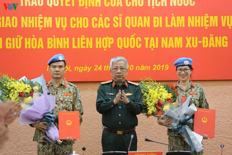 Thượng tướng Nguyễn Chí Vịnh, Thứ trưởng Bộ Quốc phòng trao quyết định cho Thượng tá Lê Ngọc Sơn và Thiếu tá Nguyễn Thị Minh Phương.
