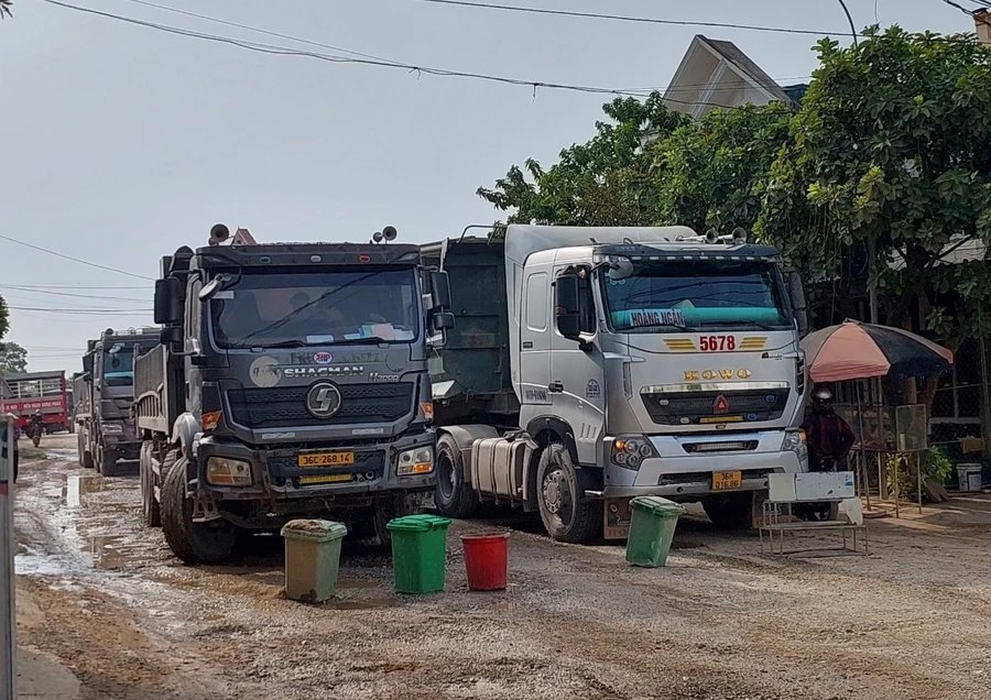 Người dân xã Minh Nghĩa mang đồ chặn xe tải. (Ảnh: NT).