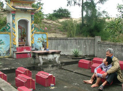 Ông Địu cùng con gái út bên cạnh 12 ngôi mộ. Ảnh:M.T Ông Địu cùng con gái út bên cạnh 12 ngôi mộ. Ảnh: M.T