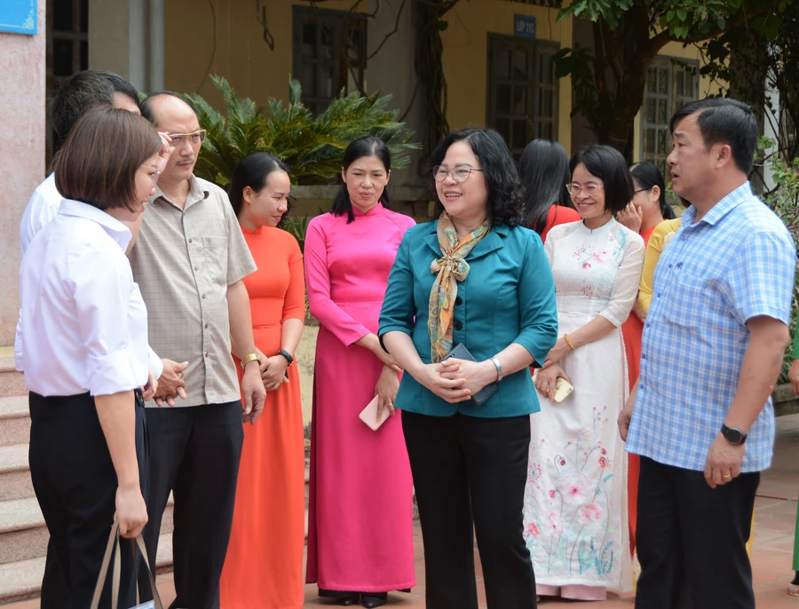 Thứ trưởng Ngô Thị Minh (áo xanh đứng giữa ) cùng các đại biểu trò chuyện với lãnh đạo trường PTDTNT THPT huyện Điện Biên.