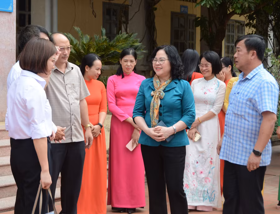 Thứ trưởng Ngô Thị Minh (áo xanh đứng giữa ) cùng các đại biểu trò chuyện với lãnh đạo trường PTDTNT THPT huyện Điện Biên.