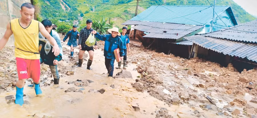 Sau cơn lũ, các thầy cô Trường Tiểu học Nhi Sơn và bà con tìm cách vào nhà lấy giấy tờ cho giáo viên 