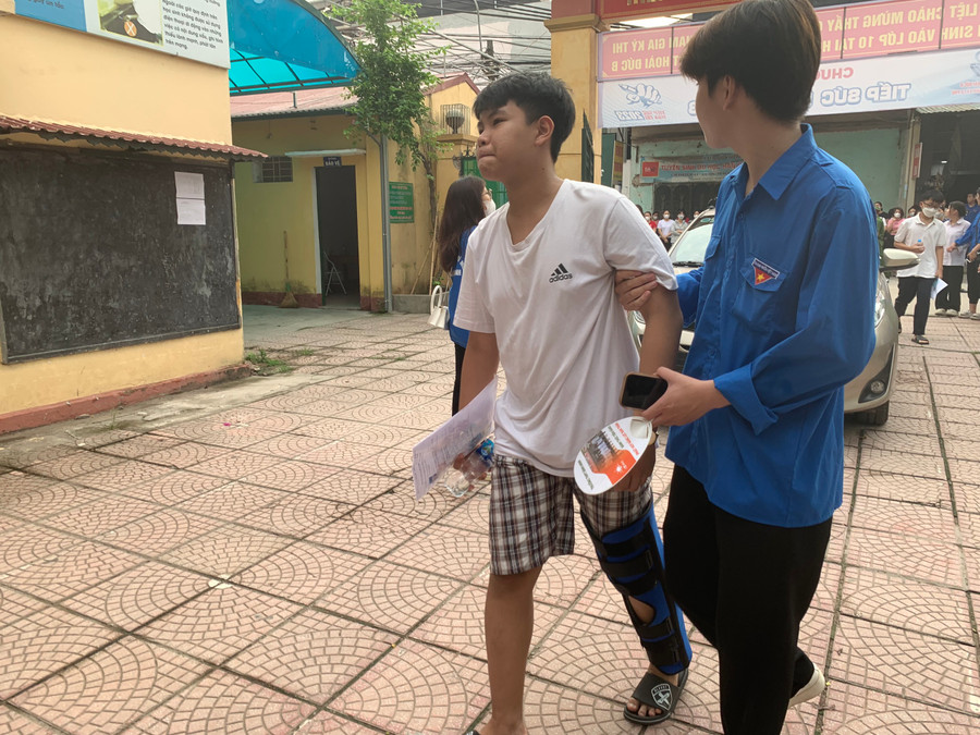 Lực lượng đoàn viên thanh niên hỗ trợ 1 nam sinh bị đau chân lên phòng thi. Lực lượng đoàn viên thanh niên hỗ trợ 1 nam sinh bị đau chân lên phòng thi.