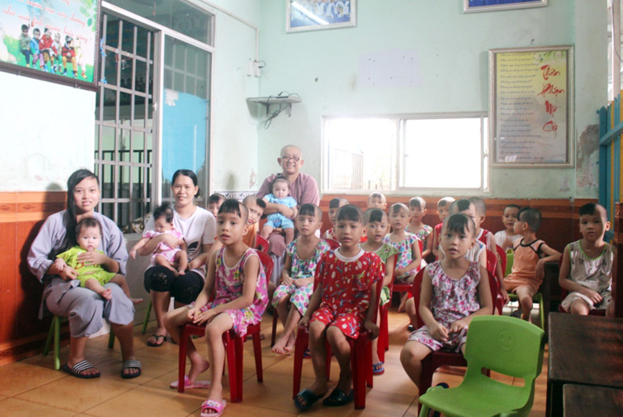 Sư cô Minh Tịnh, các bảo mẫu và các trẻ mồ côi đang chú ý nghe các bé đọc đồng thanh “Phép tắc người con”