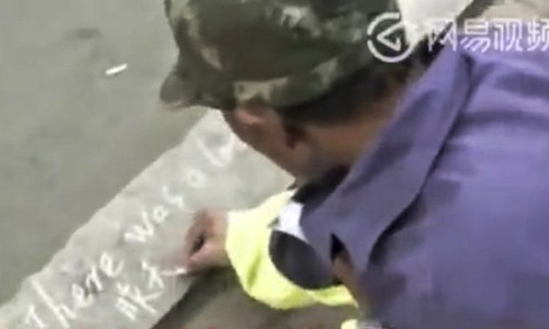 Ông Wang Shoushan ôn tập tiếng Anh bằng cách viết lên vỉa hè. Ông Wang Shoushan ôn tập tiếng Anh bằng cách viết lên vỉa hè. Ảnh: News.163.com.