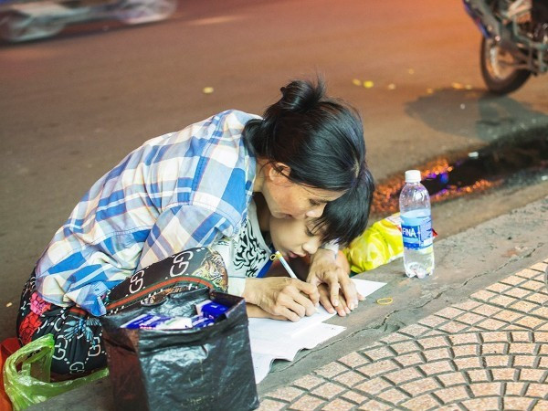 Xúc động mẹ cầm tay con dạy từng nét chữ bên lề đường TP.HCM ảnh 1 Hình ảnh mẹ cầm tay con dạy từng nét chữ bên lề đường gây xúc động mạnh