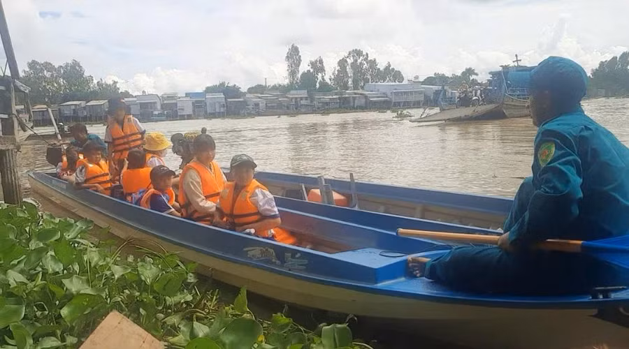 Cùng với thầy cô giáo, các lực lượng quân sự, dân quân tự vệ dùng vỏ lãi đưa rước học sinh tại các xã vùng đầu nguồn.