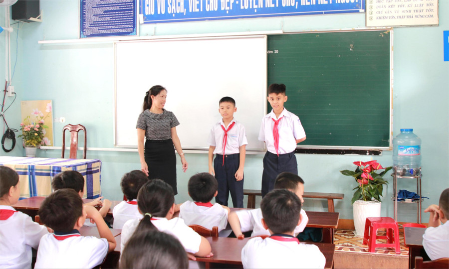 Đôi bạn Minh Triết (bên phải) và Minh Quân được tập thể lớp 5A2 và giáo viên chủ nhiệm chào đón. (Ảnh: Thành Tâm) 1-1-hs.jpg