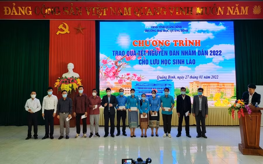 Tiến sĩ Võ Khắc Sơn - Phó Hiệu trưởng Trường Đại học Quảng Bình trao quà Tết cho lưu học sinh Lào.