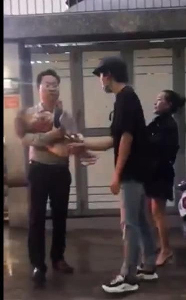Ông Lâm Hoàng Tùng, người bế con bà Thảo (Ảnh cắt từ clip). Ông Lâm Hoàng Tùng, người bế con bà Thảo (Ảnh cắt từ clip).