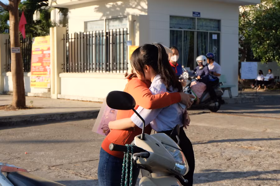 Chị Võ Thị Kim Yến ôm động viên con trước khi con vào phòng thi. Ảnh: Hoàng Vinh. Chị Võ Thị Kim Yến ôm động viên con trước khi con vào phòng thi. Ảnh: Hoàng Vinh.