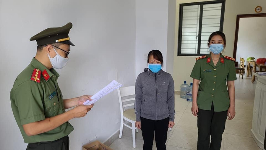 Công an tống đạt quyết định khởi tố vụ án, khởi tố bị can đối với Nguyễn Thị Kim Anh. Ảnh: Công an. 