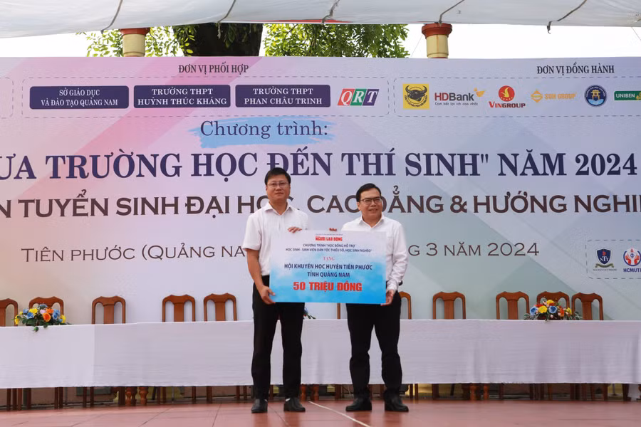 Nhà báo Dương Quang (bên phải) - Phó Tổng biên tập Báo Người Lao động trao số tiền 50 triệu đồng cho Hội khuyến học của huyện Tiên Phước, tỉnh Quảng Nam.
