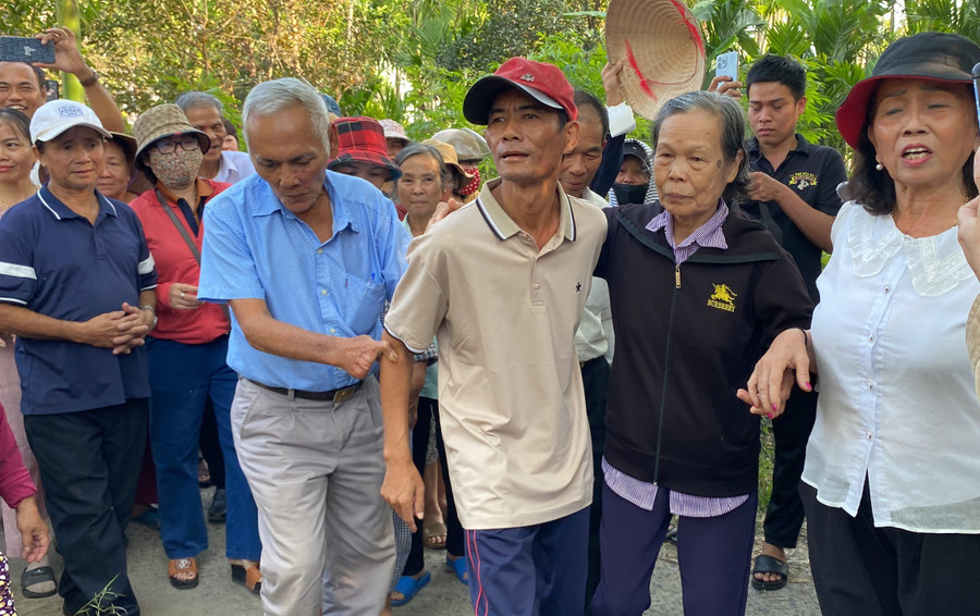 Bà Trần Thị Sốt (áo đen) đón anh Chung trở về. Bà Trần Thị Sốt (áo đen) đón anh Chung trở về.