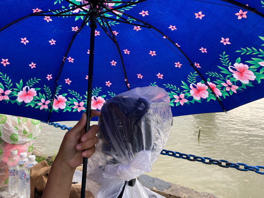 Các nhiếp ảnh gia che máy móc để tránh bị mưa ướt. Ảnh: Hoàng Vinh. Các nhiếp ảnh gia che máy móc để tránh bị mưa ướt. Ảnh: Hoàng Vinh.