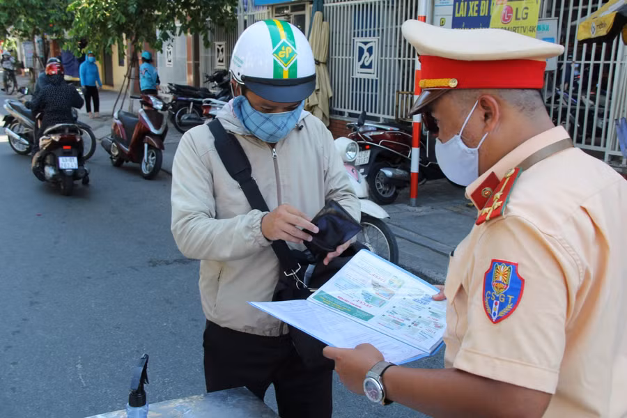 Lực lượng CSGT kiểm tra giấy tờ và thông tin người dân ở các chốt kiểm soát.