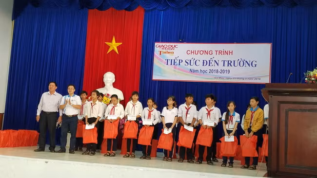 Đại diện Phòng GD&ĐT huyện Ngọc Hiển và Hội Bảo tồn lan rừng Việt Nam trao tặng học bổng và quà cho các em học sinh.