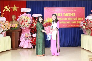 Phó Giám đốc Võ Thị Minh Duyên trao quyết định cho TS Lê Thị Thảo - Hiệu trưởng Trường THPT Cao Bá Quát. (Ảnh: TT)
