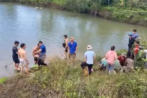 Người dân và cơ quan chức năng trục vớt 3 em nhỏ bị đuối nước.