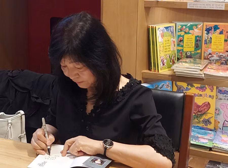 Nhà văn Shin Kyung Sook ký tặng tiểu thuyết 'Hãy chăm sóc mẹ' cho độc giả Việt Nam. Ảnh: Bình Thanh