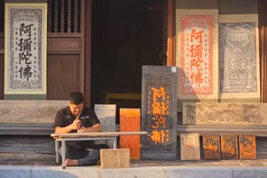 Nghệ nhân Nguyễn Công Đạt khắc bộ tranh tại chùa Vĩnh Nghiêm.