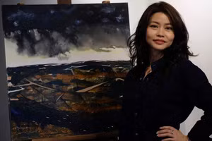 Họa sĩ Đoàn Quỳnh Như bên một tác phẩm của mình tại triển lãm 'Khiêu vũ tới trập trùng' diễn ra vào năm 2022.