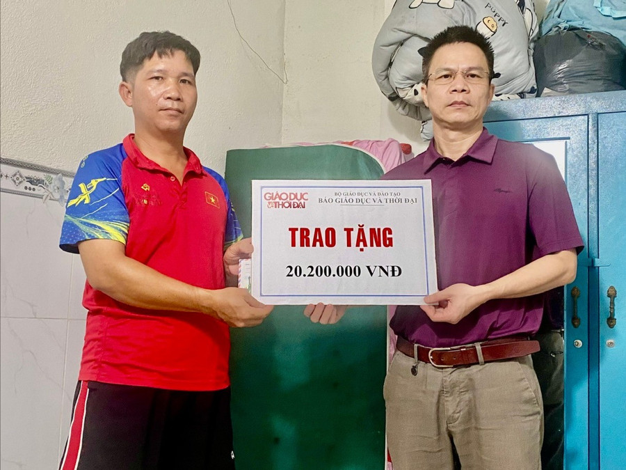 Ông Trần Mạnh Thường (phải) trao tiền ủng hộ cho cha bé gái. Ảnh: Thường Quân.