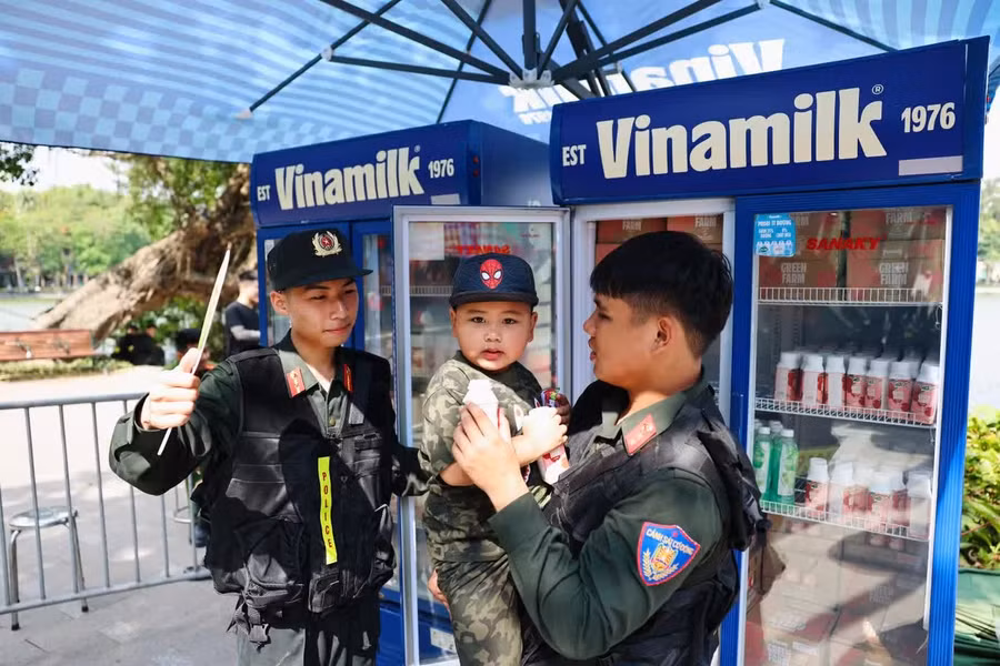 Em bé được lực lượng Cảnh sát cơ động chăm sóc, trao tặng sản phẩm dinh dưỡng Vinamilk tại chương trình. Ảnh: Vi Nam